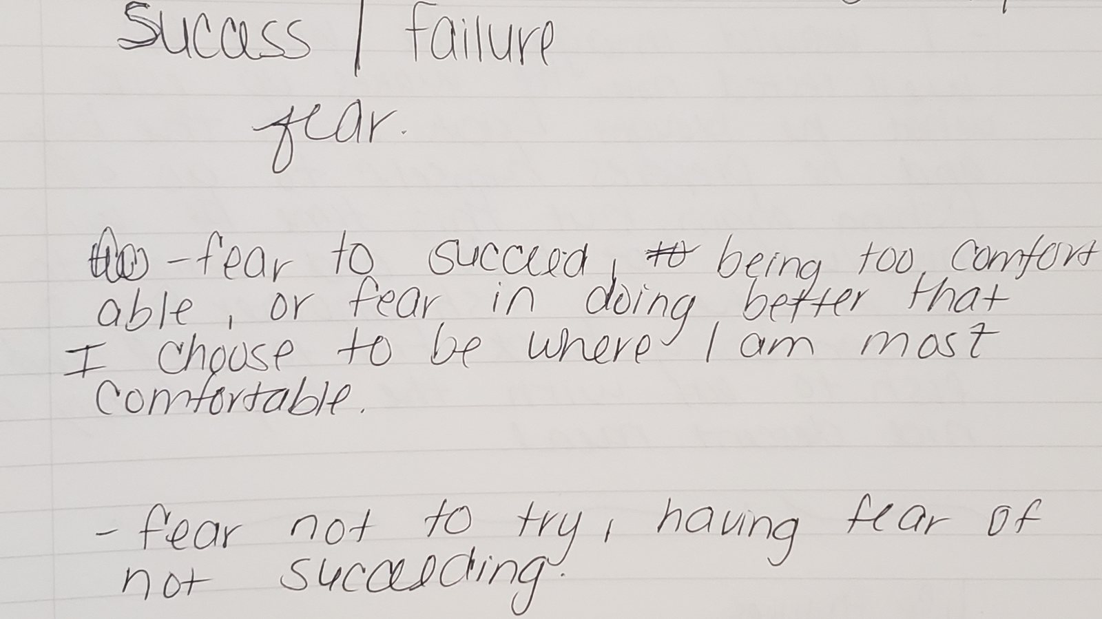 A page from a participant's notebook, handwritten in pen, working through the relationship between success, failure, and fear.